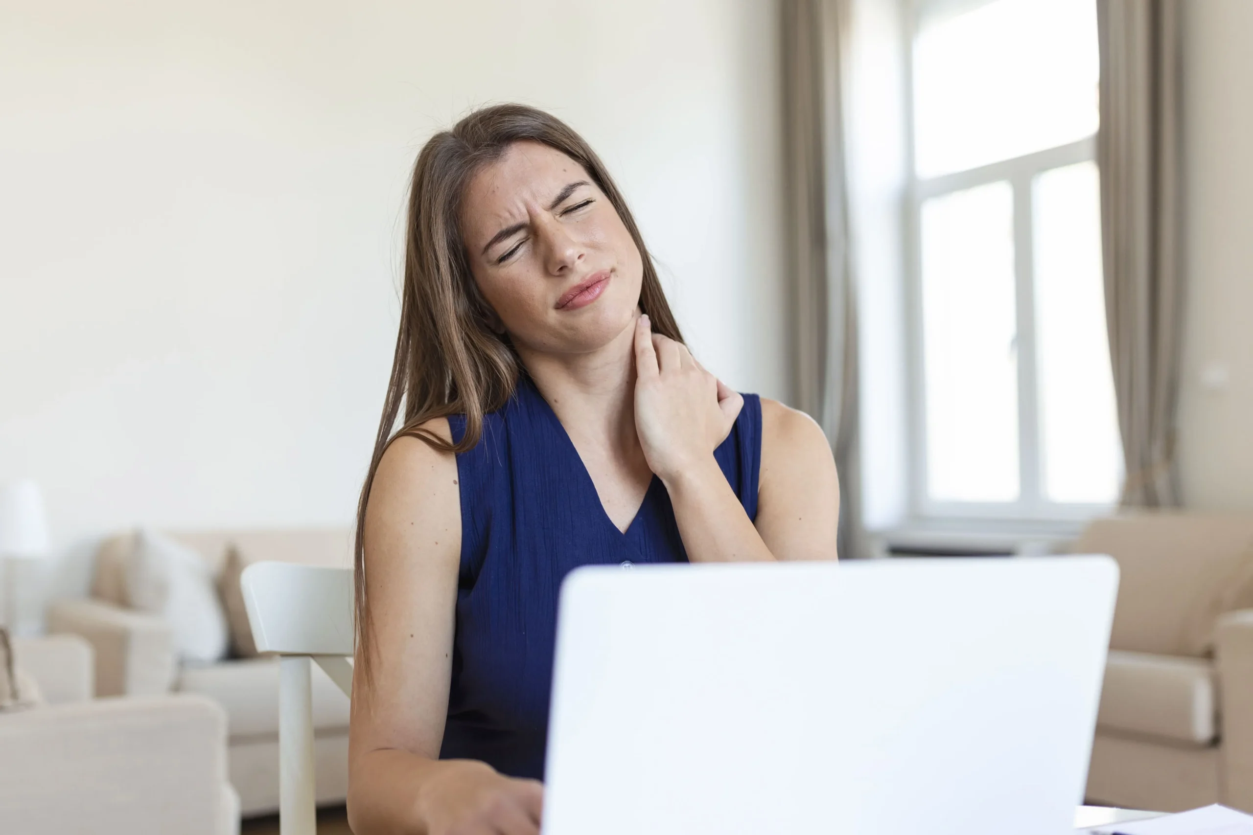 young-businesswoman-suffering-from-neckache-massaging-her-neck-while-sitting-her-working-place-home-office (1)_11zon